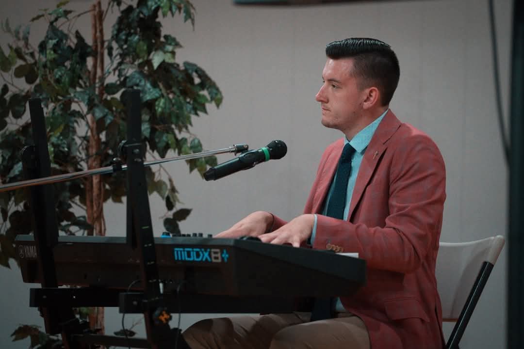 Musician Tommy Crissman plays the piano